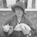 Members of the Women's Land Army with piglets, undated. Catalogue reference: MAF 59/3