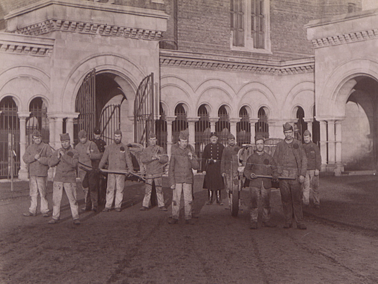 Photograph, court yard of Wormwood Scrubs Prison, groups of prisoners pulling carts. (COPY 1/420 f.180)