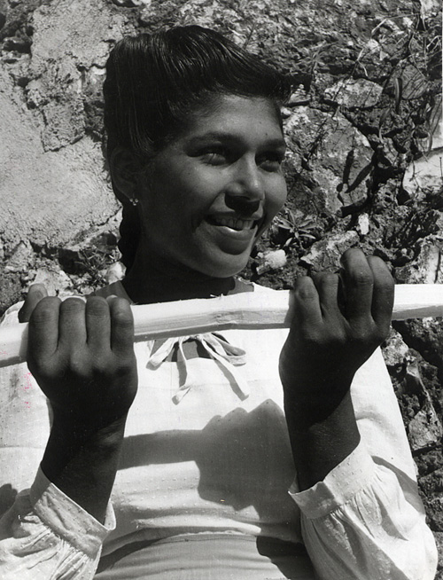 Young girl holding a sugar cane in Jamaica (INF 10/149)