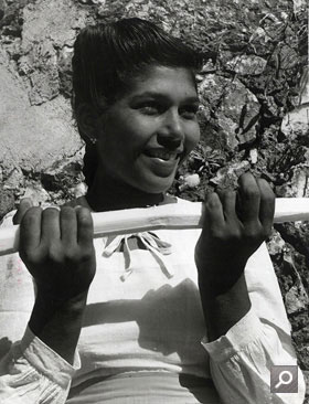Young girl holding a sugar cane in Jamaica (INF 10/149)