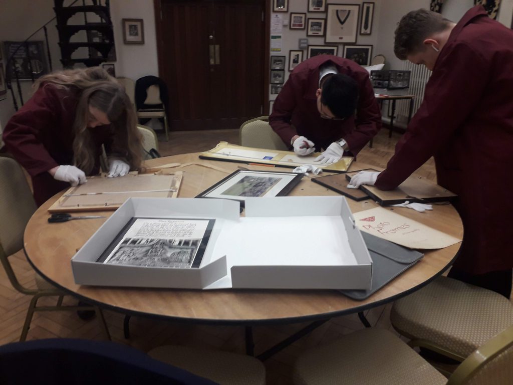 Students in Bromsgrove School's archive club working on deframing