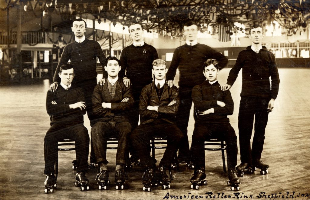 A group of men on rollerskates, one row standing, another sitting in front