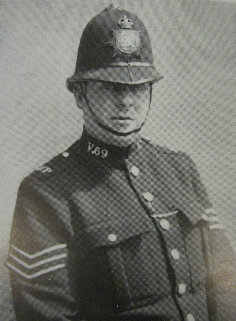 A black and white image of a policeman