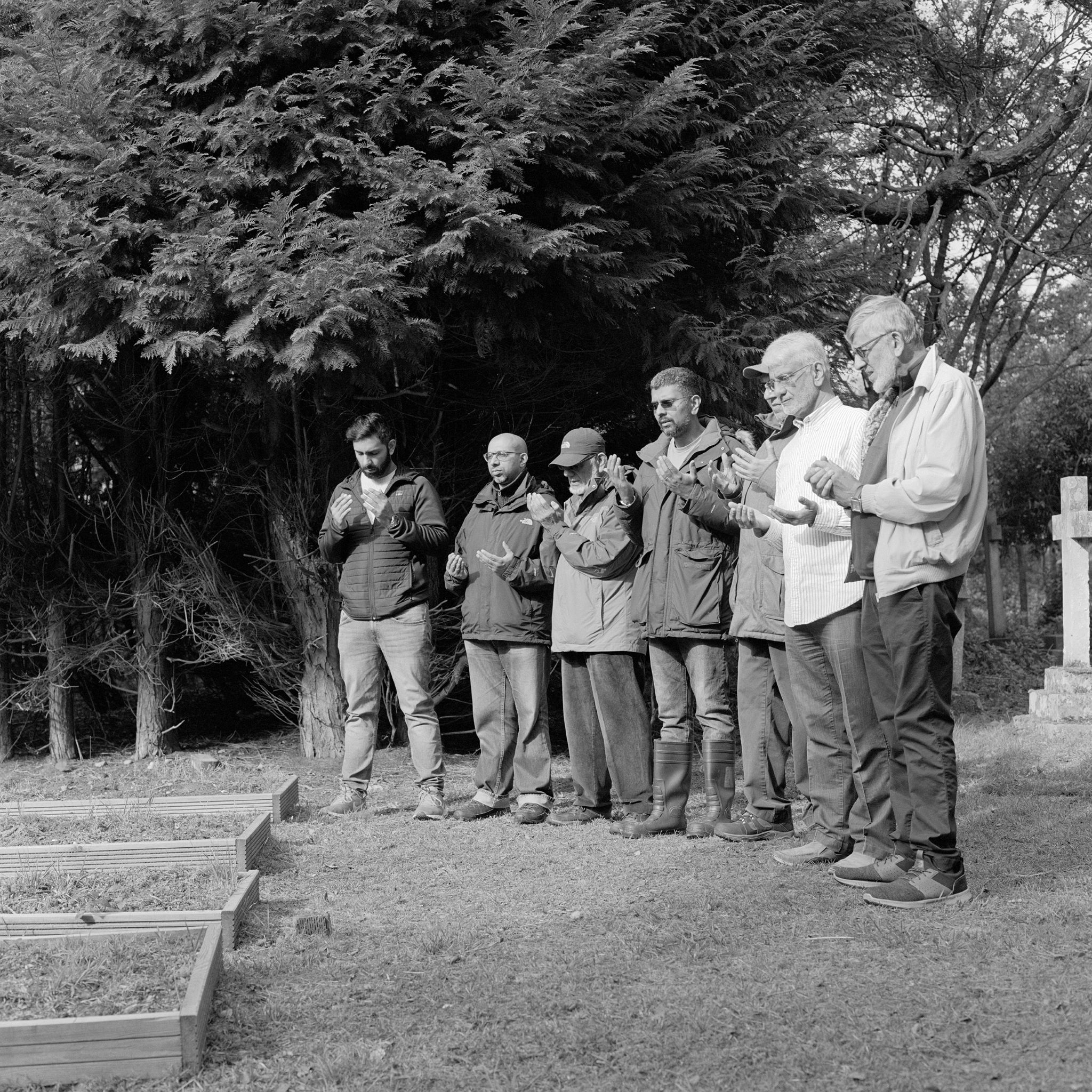 A group of people at prayer in a cemetery