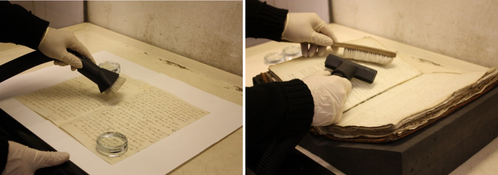 Two photos side by side - in the left image, a flat paper document is being cleaned with a vacuum brush. On the right, a large manuscript book is open, being treated with a vacuum and handheld brush combination.